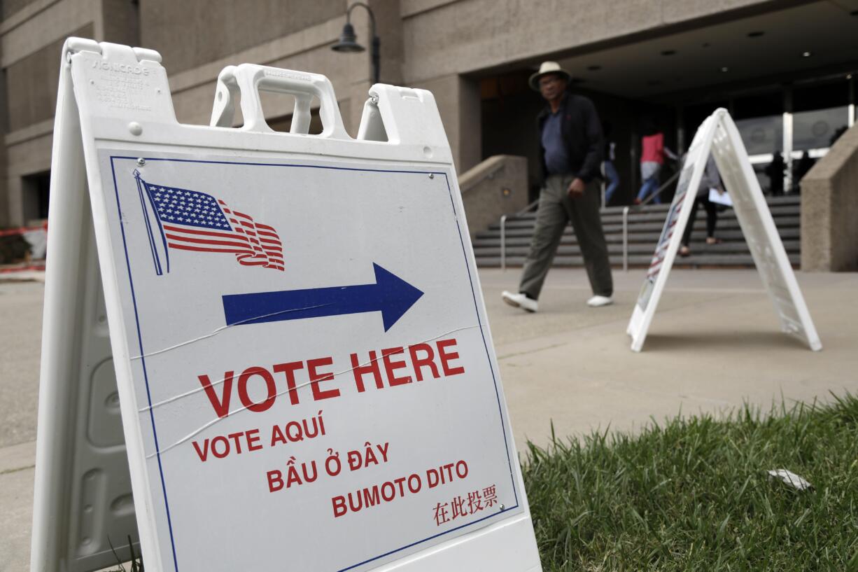 Signs direct voters outside of the Santa Clara County Registrar of Voters on Monday, Oct. 24, 2016, in San Jose, Calif. California voting rights advocates say they will monitor more polling places than usual on Election Day amid concerns about possible voter intimidation stemming from GOP presidential nominee Donald Trump's repeated assertions that the election is rigged against him.