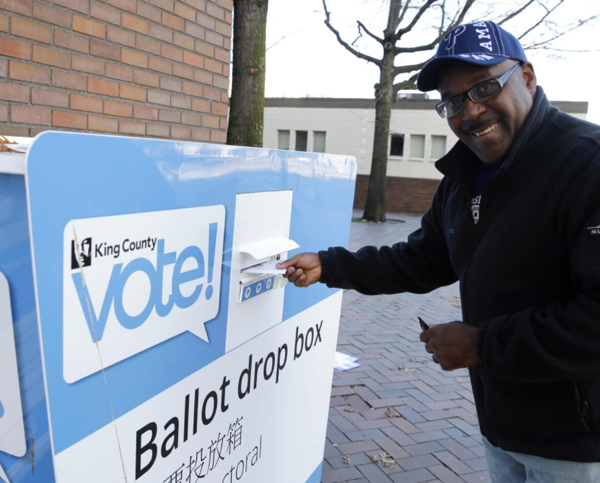 Gus Clark deposits his vote-by-mail ballot in a collection box, Thursday, Nov. 3, 2016, at Seattle Central College in Seattle. More than a million Washingtonians have already cast their ballots in advance of Tuesday&#039;s election, as voters decide on federal and state races, as well as ballot initiatives. (AP Photo/Ted S.