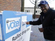 Gus Clark deposits his vote-by-mail ballot in a collection box, Thursday, Nov. 3, 2016, at Seattle Central College in Seattle. More than a million Washingtonians have already cast their ballots in advance of Tuesday&#039;s election, as voters decide on federal and state races, as well as ballot initiatives. (AP Photo/Ted S.