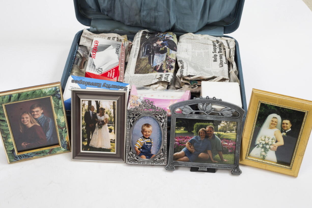 A suitcase found in a storage unit, rented by Paul McCulloh, is photographed in Yakima. Among the items inside are several framed family and wedding photos.