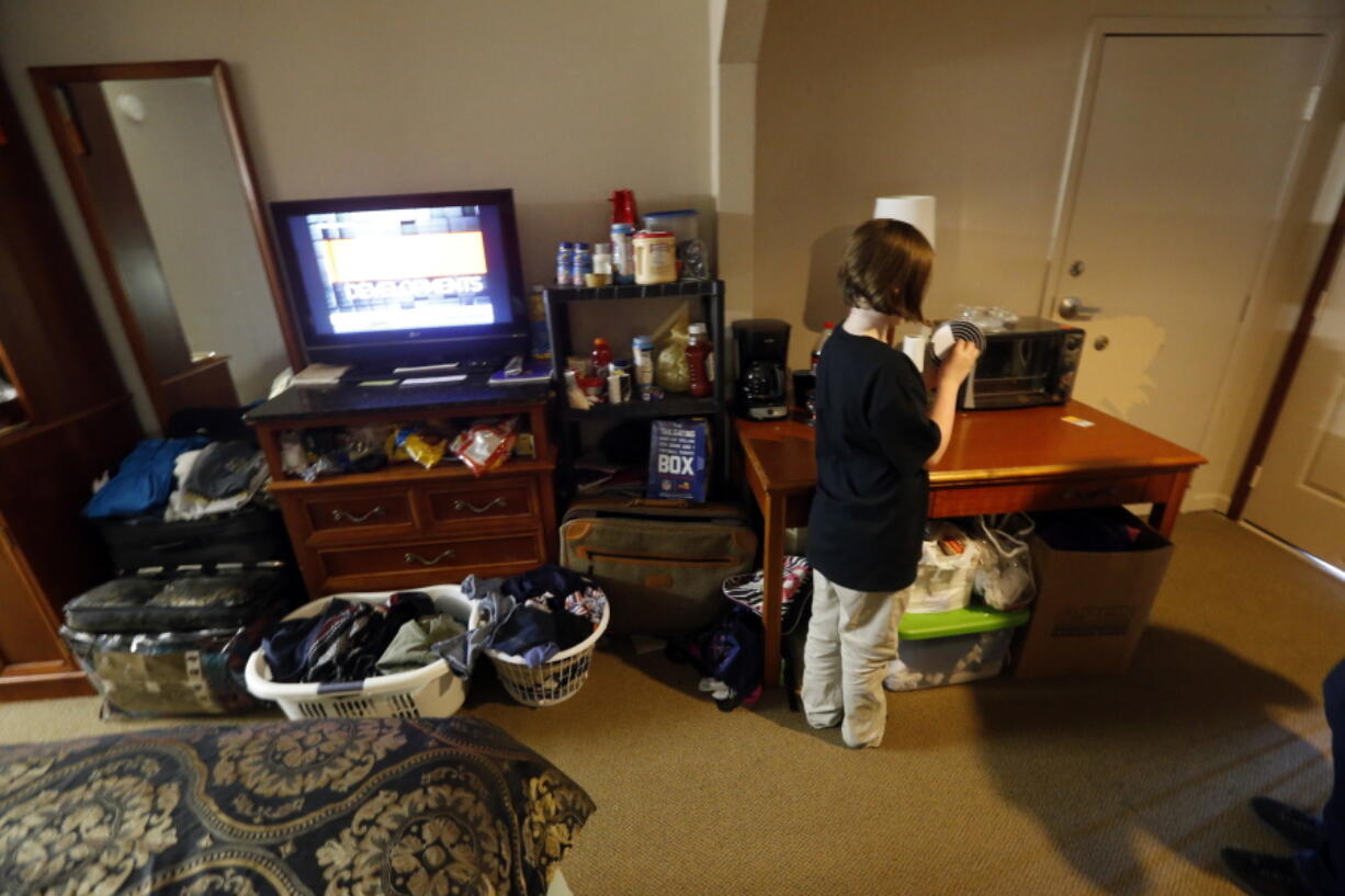 Christian Dickerson, 10 plays with a toy she made in her school since club, in the hotel room that her family now lives in, in Denham Springs, La., on Wednesday. Thousands of Louisiana families are still relying on government housing assistance three months after catastrophic flooding drove them out of their homes. For many, Thanksgiving is another reminder of how much has changed _ and how far they still have to go.