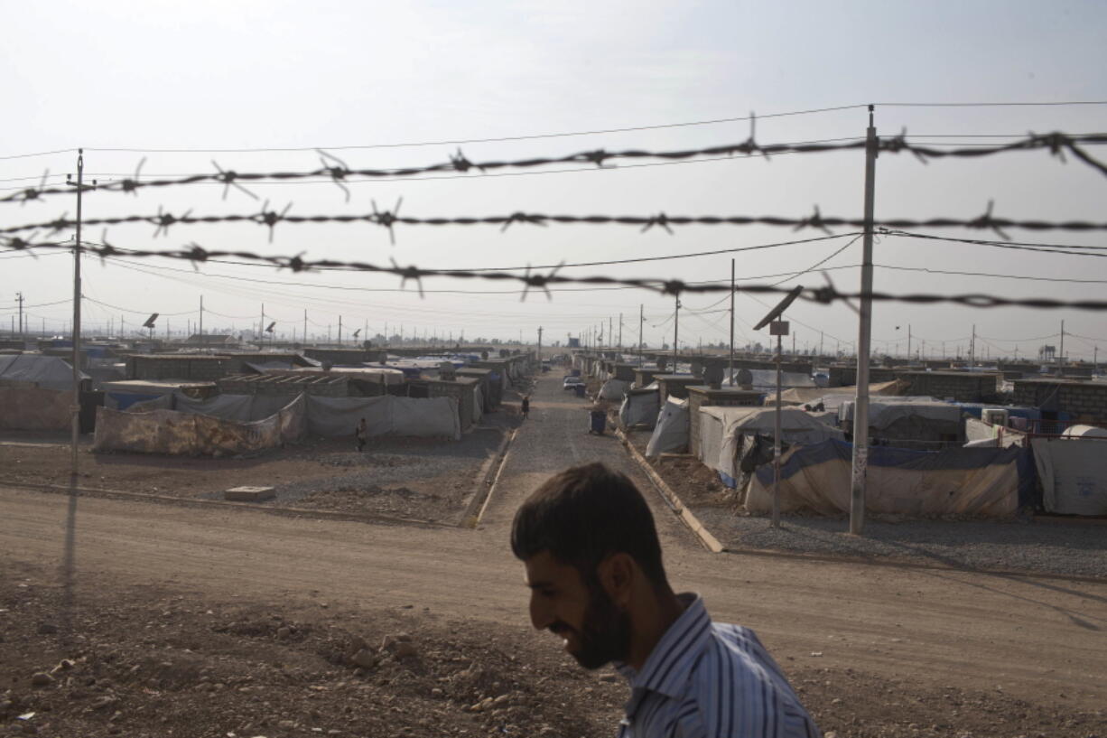 A man walks inside the Baharka camp for displaced persons on the outskirts of Irbil, Iraq, on Tuesday . Nearby Mosul, the largest city controlled by the Islamic State group, is still home to more than 1 million civilians.