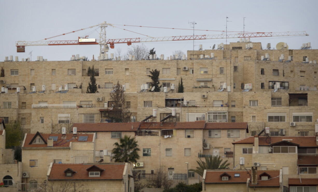 A construction crane towers over the Jewish neighborhood of Gilo in Jerusalem in 2011. A Jerusalem city official said authorities have pushed forward plans to build 181 new homes in the area.