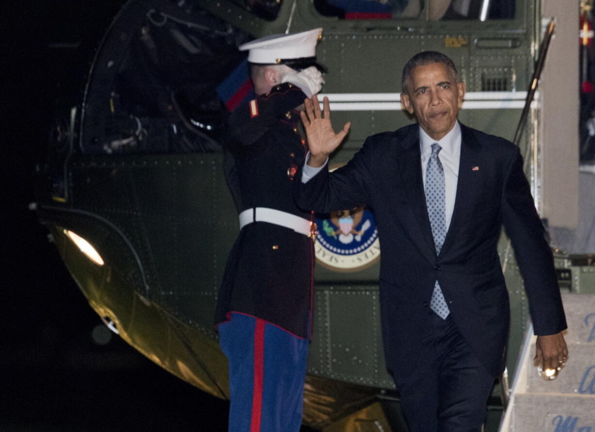 President Barack Obama waves upon arrival to the White House in Washington on Tuesday.