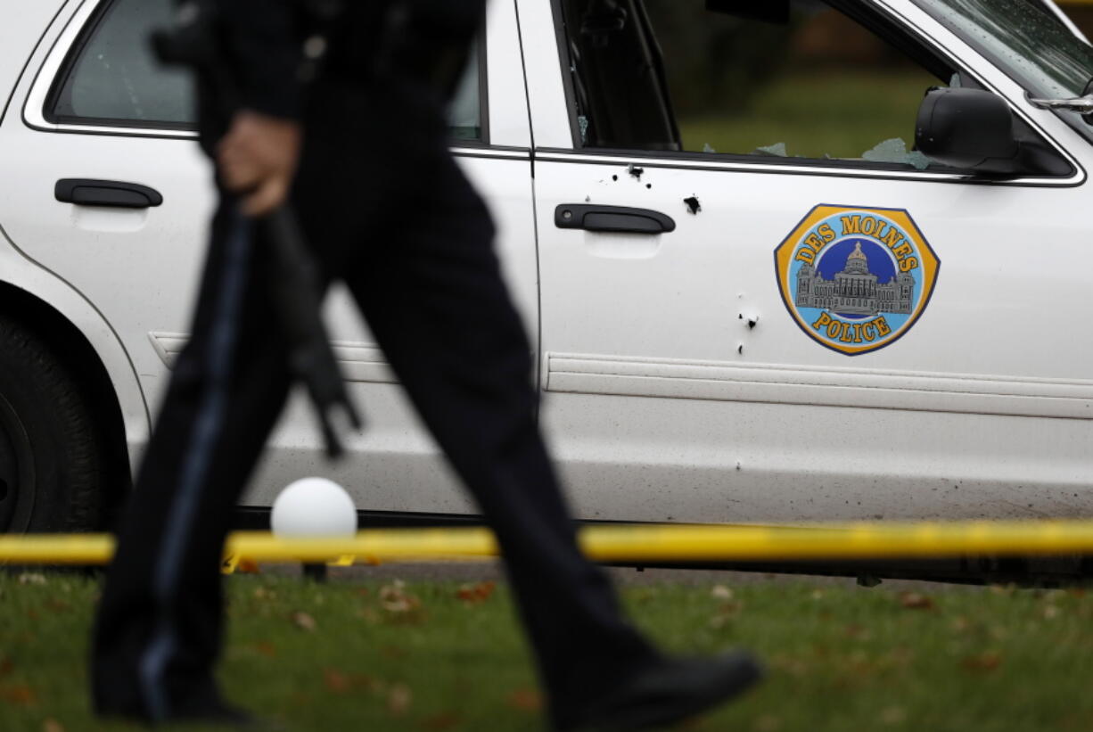 Bullet holes are seen on the side of a Des Moines police department squad car at the scene of a shootingWednesday in Des Moines, Iowa.