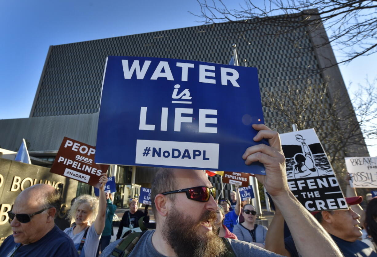 People including Steve Cramer, center, protest the Dakota Access pipeline project in front of the Richard Bolling Federal Building on Tuesday in downtown Kansas City, Mo. The company building a $3.8 billion oil pipeline sought a federal judge&#039;s permission Tuesday to circumvent President Barack Obama&#039;s administration and move ahead with a disputed section of the project in North Dakota, as opponents held protests across the country urging it to be rejected.