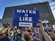 People including Steve Cramer, center, protest the Dakota Access pipeline project in front of the Richard Bolling Federal Building on Tuesday in downtown Kansas City, Mo. The company building a $3.8 billion oil pipeline sought a federal judge&#039;s permission Tuesday to circumvent President Barack Obama&#039;s administration and move ahead with a disputed section of the project in North Dakota, as opponents held protests across the country urging it to be rejected.