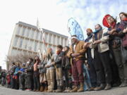 Dakota Pipeline protesters stand arm-in-arm at the intersection of Rosser Avenue and Fourth Street in downtown Bismarck, N.D., after marching from the state Capitol to the William L. Guy Federal Building on Monday.