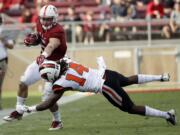 Stanford running back Christian McCaffrey (5) is tackled by Oregon State cornerback Treston Decoud (14) during the second half Saturday.