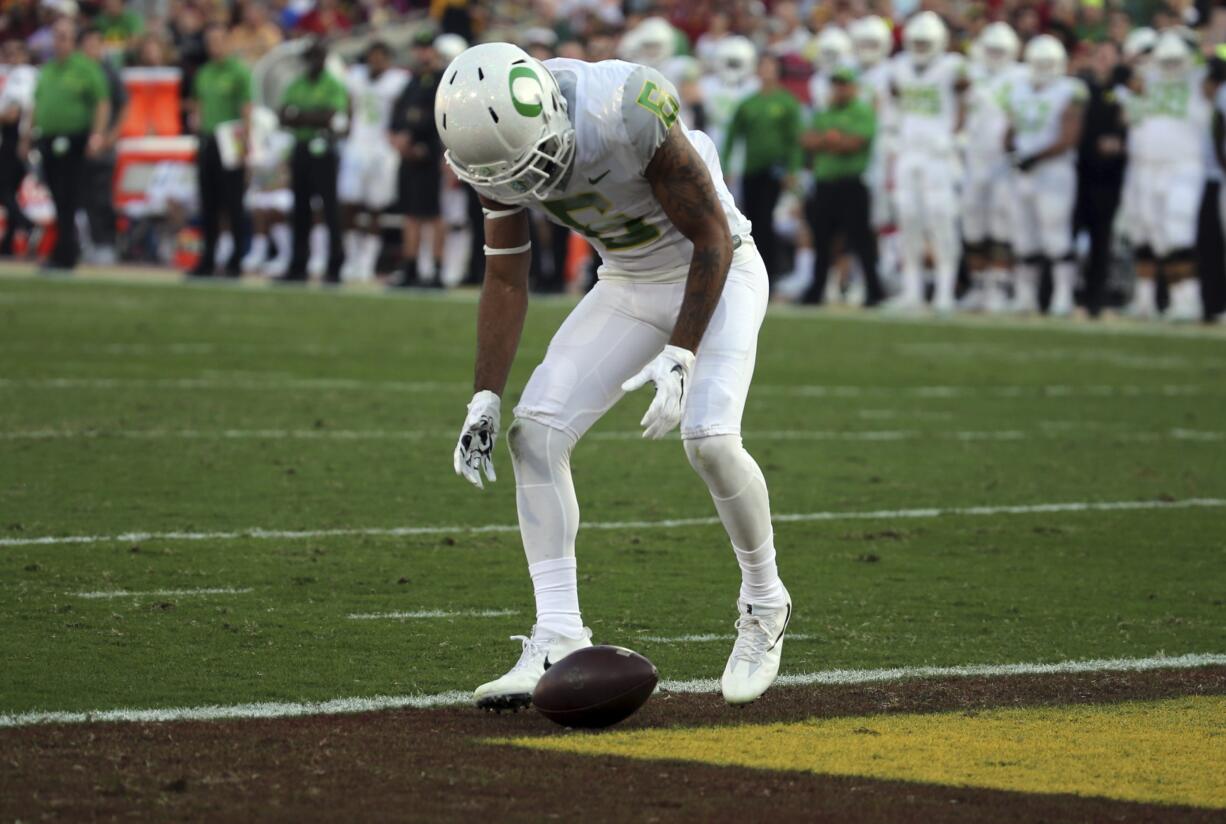 Oregon defensive back Mattrell McGraw (9) stares at the ball after dropping a kickoff from Southern California .