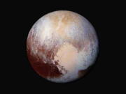 This 2015 combination of images captured by the New Horizons spacecraft, with enhanced colors, shows differences in the composition and texture of Pluto&#039;s surface.