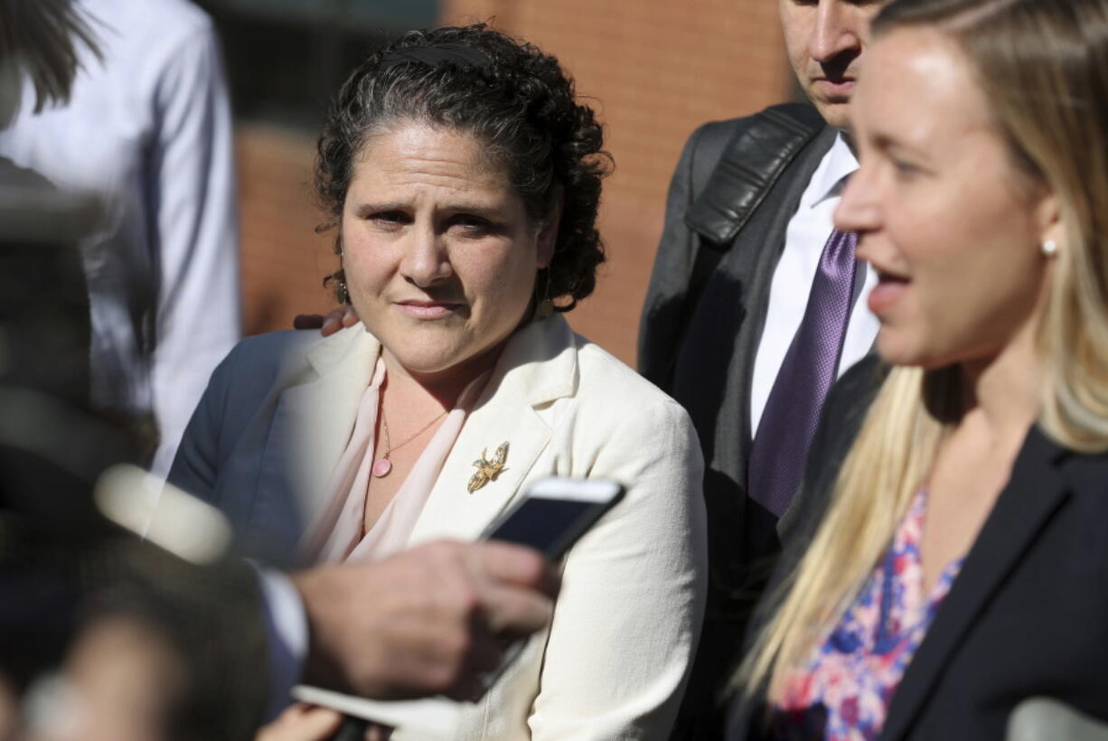 Nicole Eramo, left, listens to attorney Libby Locke, right, speak with the media outside the federal courthouse in Charlottesville, Va., on Friday, Nov. 4, 2016. A federal jury on Friday found Rolling Stone magazine, its publisher and a reporter defamed Eramo in a discredited story about gang rape at a fraternity house of the university.   (Ryan M.