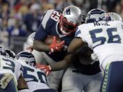 Seattle Seahawks defenders Tony McDaniel, (93), K.J. Wright (50) and Cliff Avril (56) stop New England Patriots running back LeGarrette Blount (29) at the goal line near the end of an NFL football game, Sunday, Nov. 13, 2016, in Foxborough, Mass. The Seahawks won 31-24.