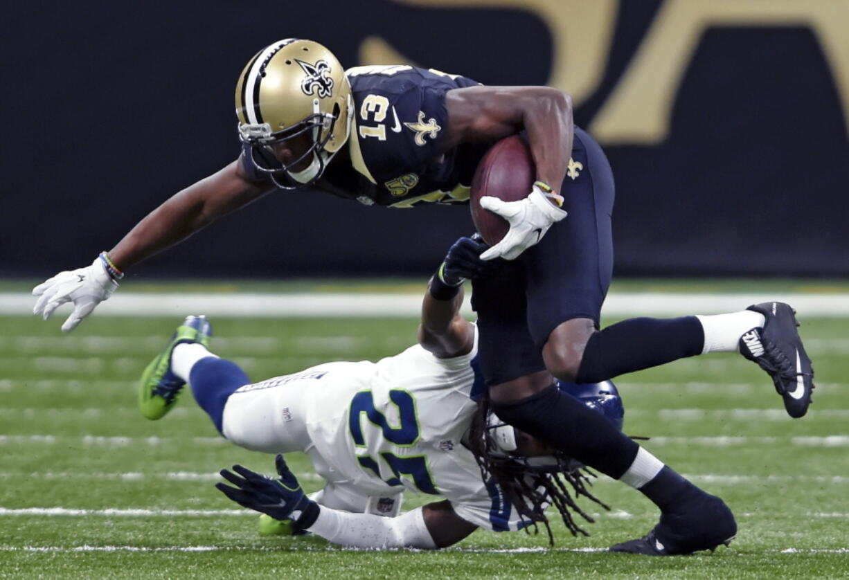 Seattle Seahawks cornerback Richard Sherman (25) tries to tackle New Orleans Saints wide receiver Michael Thomas (13) in the first half of an NFL football game in New Orleans, Sunday, Oct. 30, 2016.