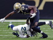 Seattle Seahawks cornerback Richard Sherman (25) tries to tackle New Orleans Saints wide receiver Michael Thomas (13) in the first half of an NFL football game in New Orleans, Sunday, Oct. 30, 2016.