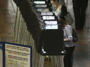 People vote at a polling station on the first day of early voting in Miami-Dade County for the general election in Miami.