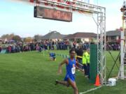 Silas Griffith of Ridgefield crosses the finish line upon winning the Class 2A race at the State Cross Country Championships on Saturday in Pasco.