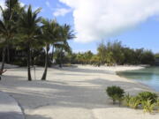 A couple stroll along the sidewalk Nov. 1 next to the beach at Le Meridien resort in Bora Bora. Bora Bora is 160 miles from Tahiti, with a balmy and relatively consistent temperature of 80 degrees.