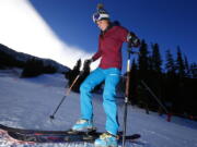 Anna Marie Migl, from Denver, steps into her bindings Oct. 21 before taking a run on opening day of ski season at Arapahoe Basin Ski Area in Colorado.