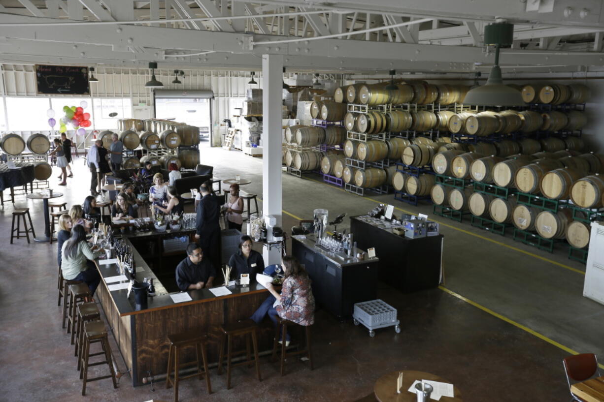 People taste wine Oct. 7 at the Riggers Loft Wine Company in Richmond, Calif. The winery is located in a historic building that once played a vital role in building the Liberty and Victory ships of World War II.