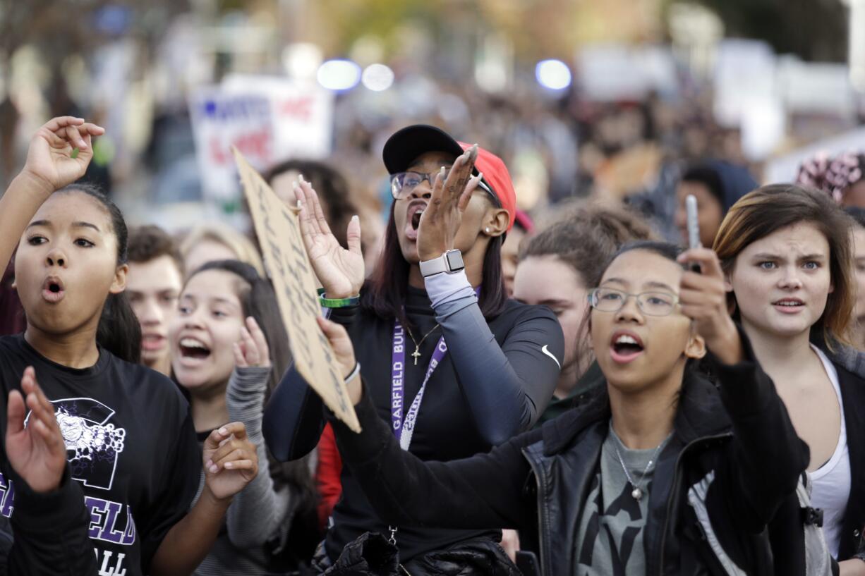 FILE - In this Nov. 14, 2016 file photo, students from Garfield High School march to rally with other students who walked out to protest the election of Donald Trump as president in Seattle. Though too young to vote, thousands of high school students from Seattle to Silver Spring, Md., have taken to the streets since Trump's election to protest his proposed crackdown on illegal immigration and his rude comments about women.