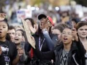 FILE - In this Nov. 14, 2016 file photo, students from Garfield High School march to rally with other students who walked out to protest the election of Donald Trump as president in Seattle. Though too young to vote, thousands of high school students from Seattle to Silver Spring, Md., have taken to the streets since Trump's election to protest his proposed crackdown on illegal immigration and his rude comments about women.