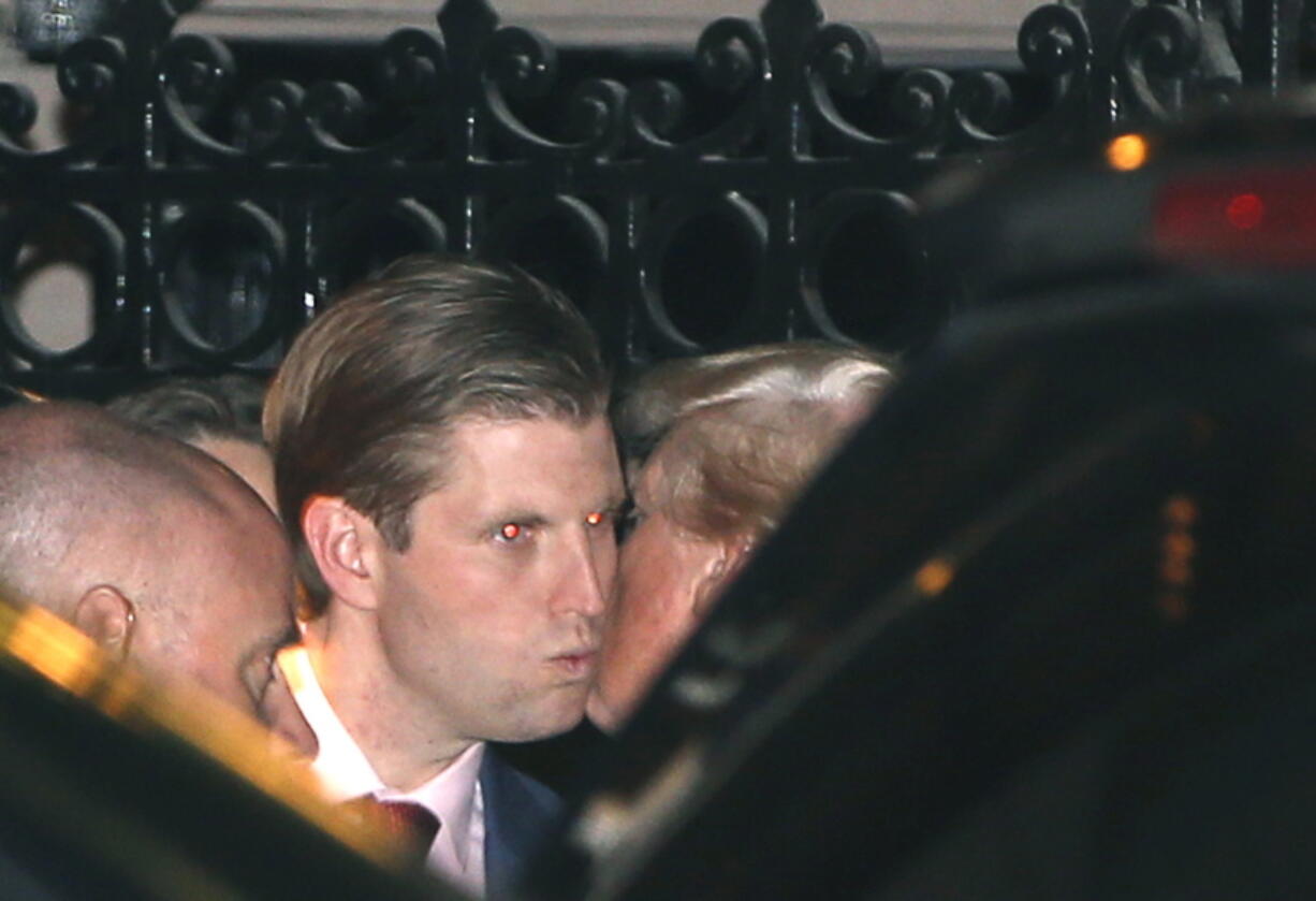 President-elect Donald Trump, right, kisses son Eric farewell after dining at the 21 Club on Tuesday in New York.