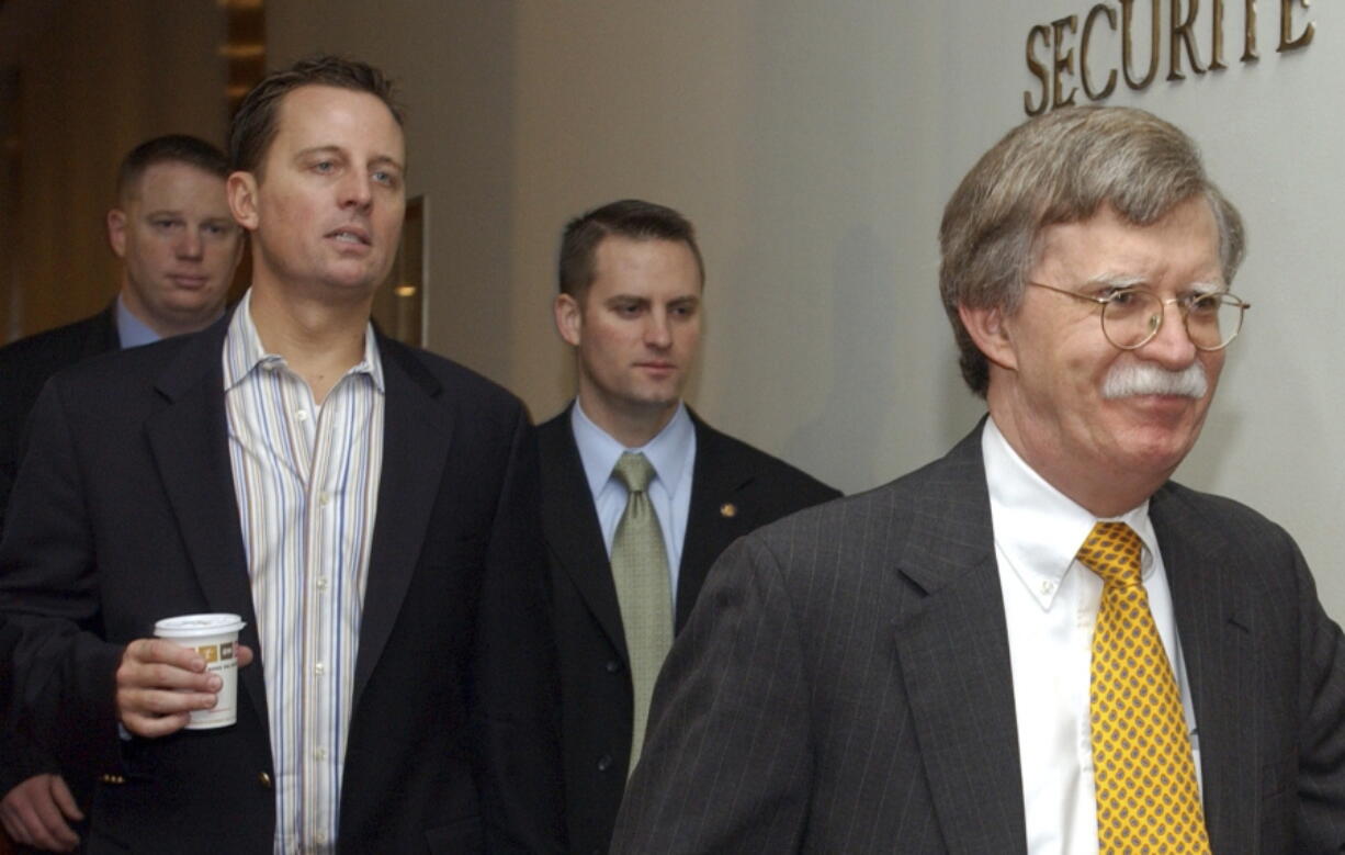 Richard Grenell, left, walks with John Bolton, the United States ambassador to the United Nations, right, to a Security Council meeting on an Arab-backed draft resolution condemning the Israeli military offensive in Gaza at the United Nations headquarters in New York.