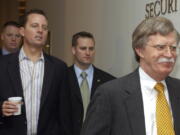 Richard Grenell, left, walks with John Bolton, the United States ambassador to the United Nations, right, to a Security Council meeting on an Arab-backed draft resolution condemning the Israeli military offensive in Gaza at the United Nations headquarters in New York.