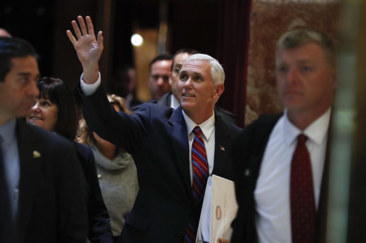 Vice President-elect Mike Pence waves as he arrives at Trump Tower on Tuesday in New York.