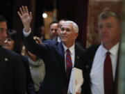 Vice President-elect Mike Pence waves as he arrives at Trump Tower on Tuesday in New York.