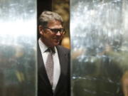 An elevator door closes as former Texas Gov. Rick Perry arrives at Trump Tower on Monday in New York.