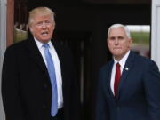 President-elect Donald Trump, left, talks to media as he and Vice President-elect Mike Pence arrive at the Trump National Golf Club Bedminster clubhouse Sunday in Bedminster, N.J..