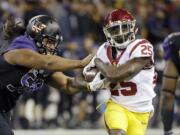 Washington defensive lineman Vita Vea, left, pushes Southern California running back Ronald Jones II on a carry by Jones in the first half of an NCAA college football game Saturday, Nov. 12, 2016, in Seattle.