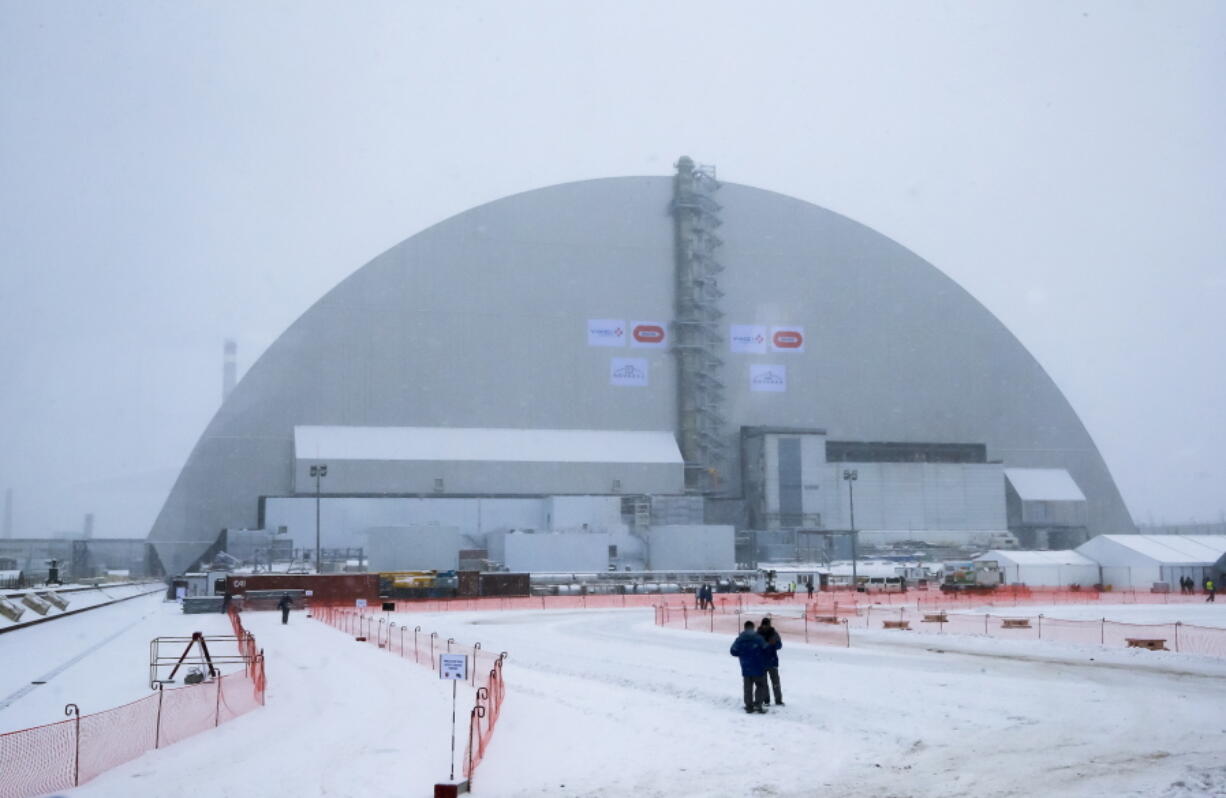 Workers inspect the New Safe Confinement movable enclosure Tuesday at the nuclear power plant in Chernobyl, Ukraine. The enclosure is a significant step toward liquidating the remains of the world&#039;s worst nuclear accident.