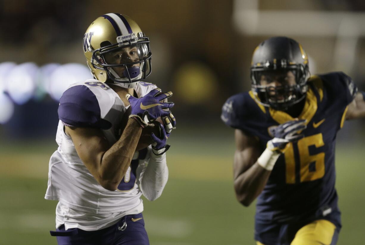 Washington's Dante Pettis, left, runs past California's Chibuzo Nwokocha (16) for a touchdown Saturday (BEN MARGOT/Associated Press)