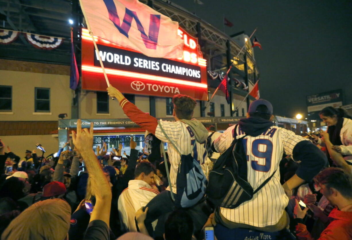 Chicago Cubs fans celebrate in front of Wrigley Field in Chicago on Wednesday after the Cubs defeated the Cleveland Indians 8-7 in Game 7 of the baseball World Series in Cleveland.