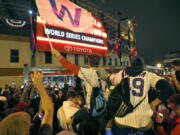 Chicago Cubs fans celebrate in front of Wrigley Field in Chicago on Wednesday after the Cubs defeated the Cleveland Indians 8-7 in Game 7 of the baseball World Series in Cleveland.