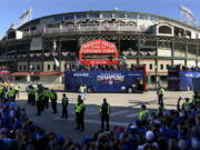 A parade honoring the World Series champion Chicago Cubs passes Wrigley Field Friday, Nov. 4, 2016, in Chicago.