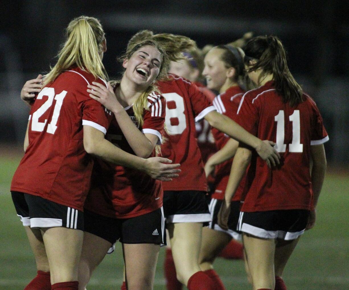 Papermakers's Sarah Davidson (21) hugs Morgan Winston after Winston scored a second half goal to help beat the West Valley of Yakima' Rams 3-0 in the WIAA 4A state championship match November 19, 2016 at  Sparks Stadium in Puyallup, WA.