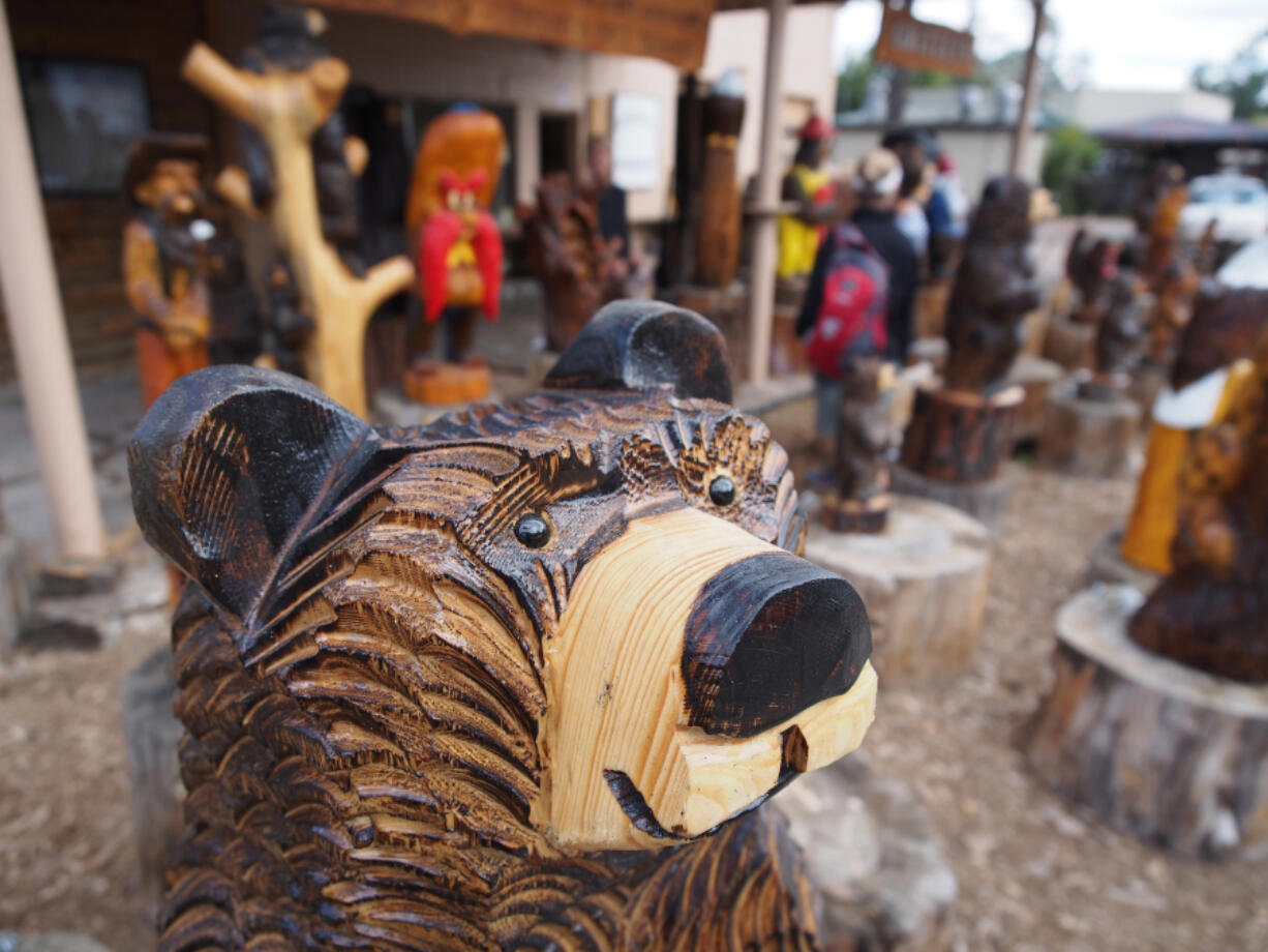 A carved bear greats visitors to Grizzlie&#039;s Workshop in downtown Ruidoso, N.M.