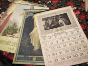 Vintage calendars -- including one from 1913 -- cover Cyrilla Gleason&#039;s kitchen table at her home in Vancouver. Gleason takes vintage calendars from her collection and reuses them when the days and dates match up with the current year.