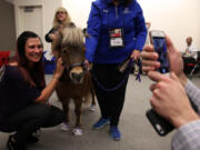 Roosevelt University staff member Amanda DePalma has her photo taken with Lunar.