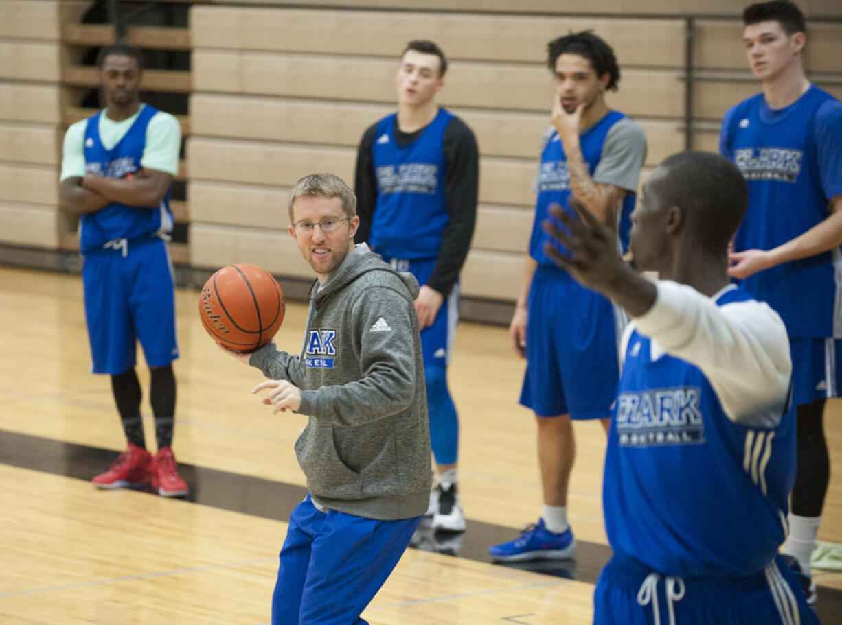 Clark College head coach Alex Kirk, with ball, works with the team Monday afternoon, Nov. 23, 2015 at O&#039;Connell Sports Center.