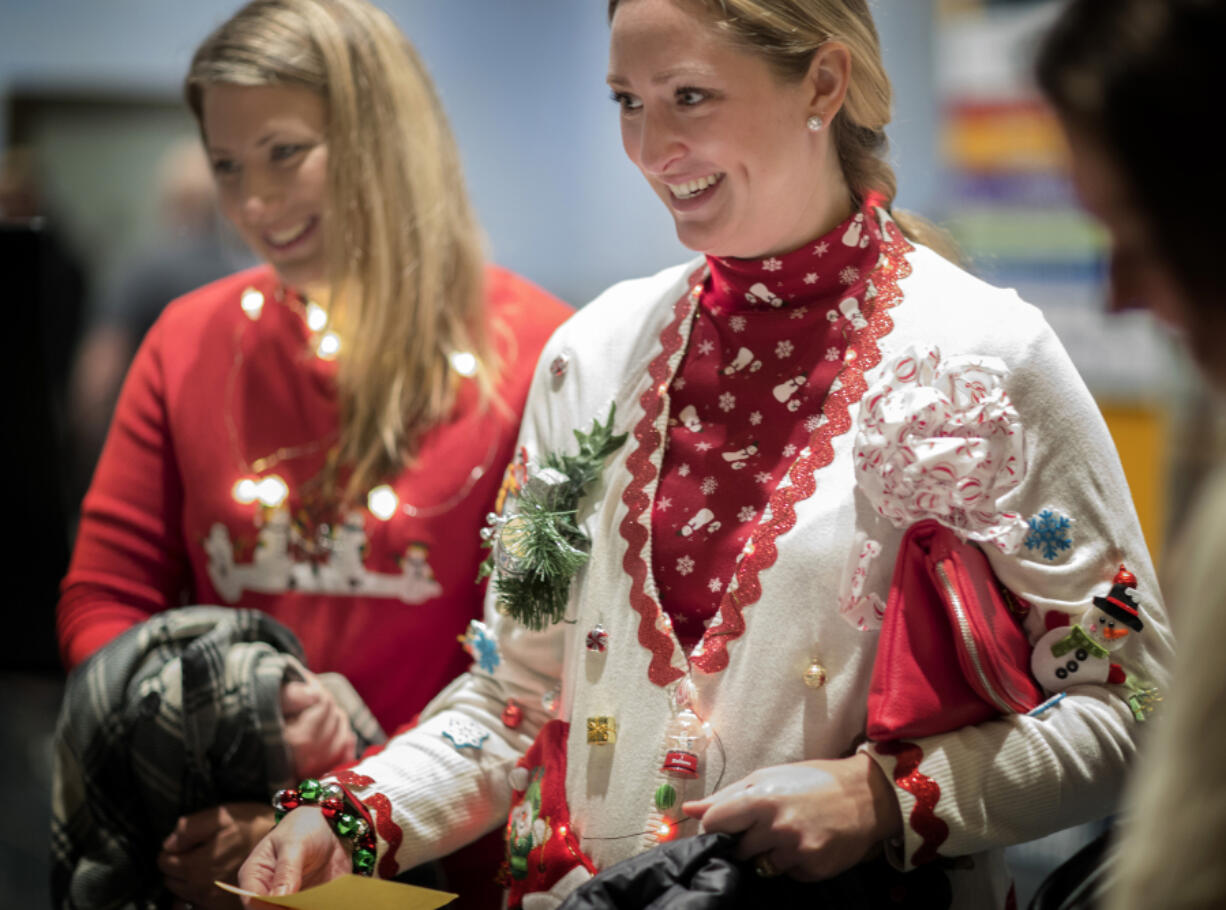 Megahn Hollenbeck and Melinda Rodger, both of Blaine, Minn., wore holiday sweaters to History Flirt: &#039;90s Holidays at the Minnesota History Center.