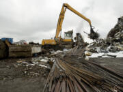 Scrap metal is loaded onto a conveyor and into a shredder at Pacific Coast Shredding.