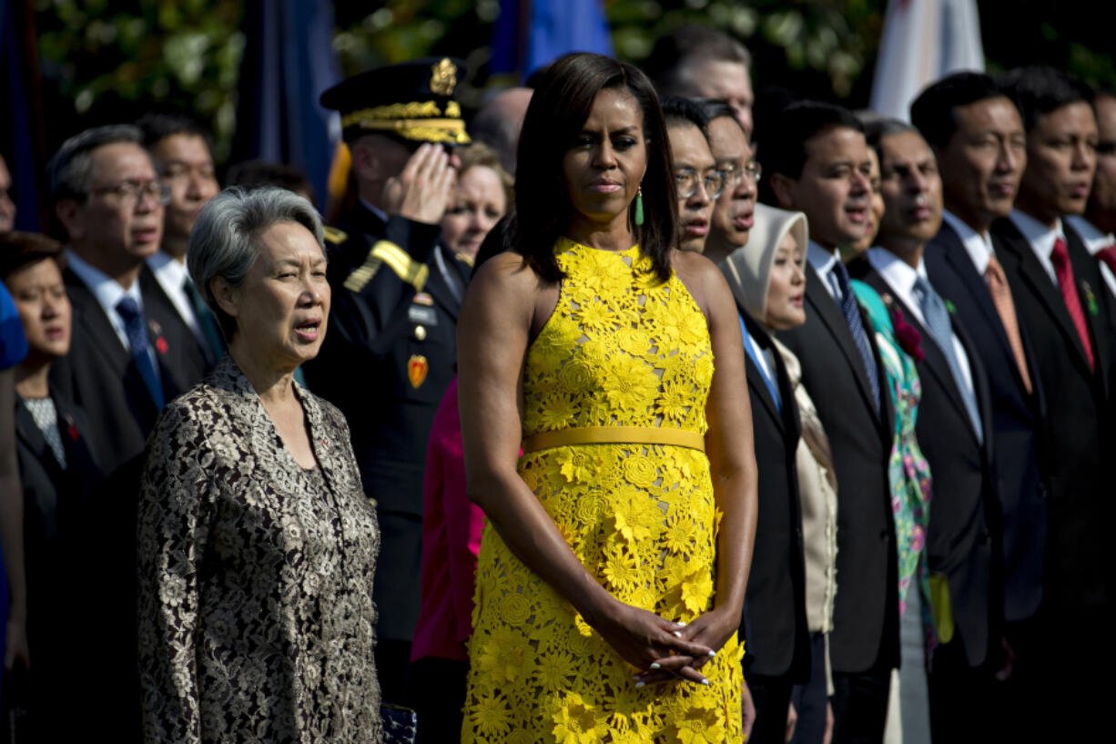 First Lady Michelle Obama, center, and Ho Ching, wife of Lee Hsien Loong, Singapore&#039;s prime minster, participate in an official arrival ceremony at the White House on Aug. 2.