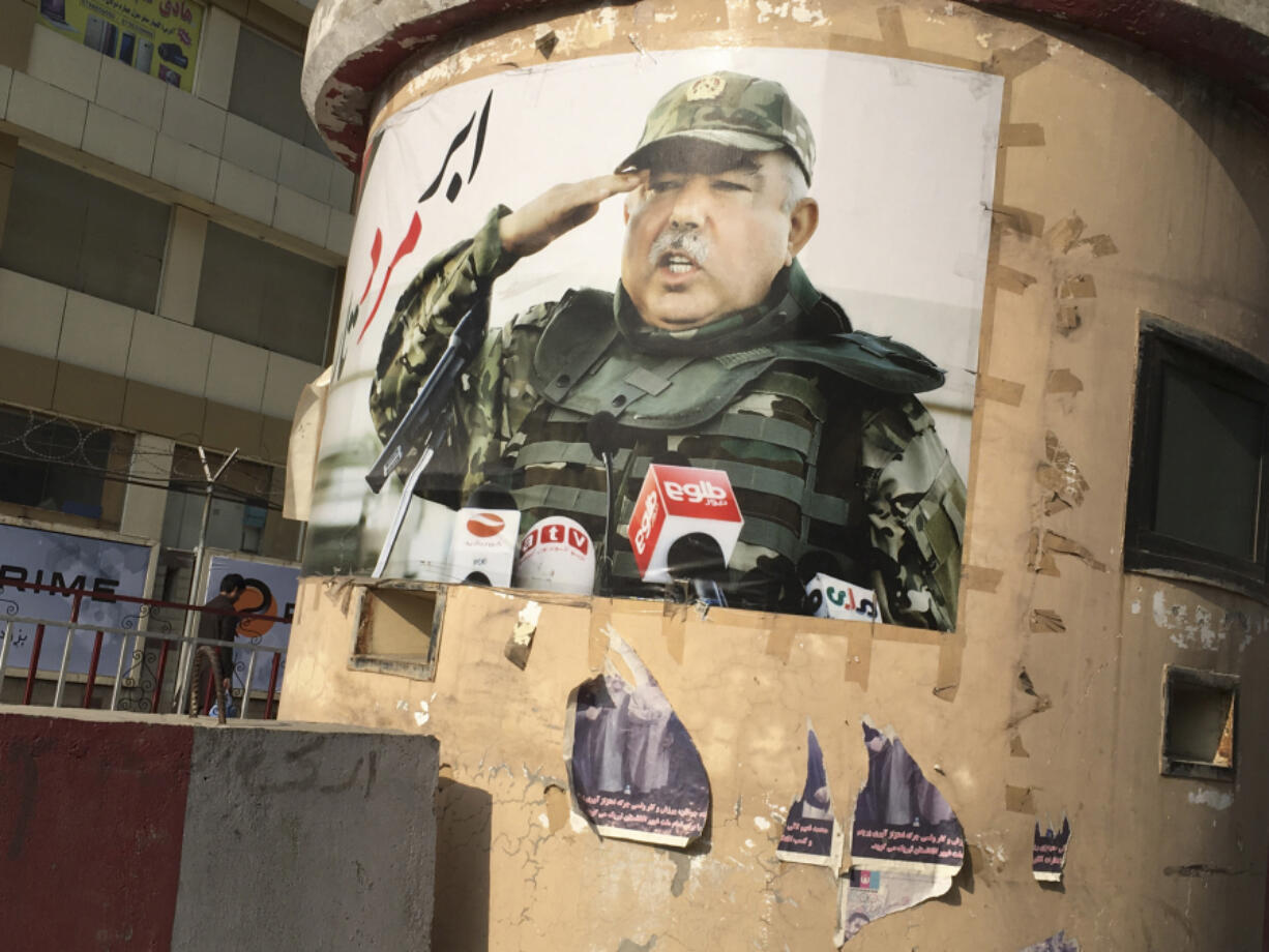 A poster depicting Afghan Vice President Abdurrashid Dostum, a once-powerful warlord who has been accused of a brutal assault, looms above a Kabul street.