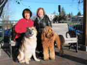 Kathy Denney, left, with German shepherd Shelby, and Tessa Rawitzer, with Australian labradoodle Arnold, take a break from dog walking in Bellingham.