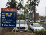 A sign at Clark College helps visitors in the fall find their way to places around campus including the new STEM Building, background.